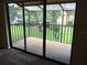 Screened balcony with tile flooring and view of green space at 4709 Capri Pl # 189, Orlando, FL 32811