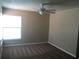 Bright bedroom with neutral walls, carpet, and a ceiling fan at 4709 Capri Pl # 189, Orlando, FL 32811