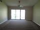 Primary bedroom with sliding glass doors leading to balcony at 4709 Capri Pl # 189, Orlando, FL 32811