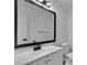 Bathroom with white vanity and black framed mirror at 4940 Spring Run Ave, Orlando, FL 32819