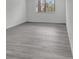 Bright bedroom with grey wood-look floors and large window at 4940 Spring Run Ave, Orlando, FL 32819