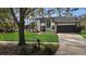 Renovated home with a white exterior, black accents, and a well-manicured lawn at 4940 Spring Run Ave, Orlando, FL 32819