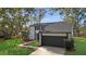 Modern two-story house with a dark-colored garage and walkway at 4940 Spring Run Ave, Orlando, FL 32819