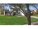 Updated home exterior with white siding, black window frames, and a lush green lawn at 4940 Spring Run Ave, Orlando, FL 32819