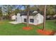 Rear view of a renovated home showcasing a patio and well-maintained yard at 4940 Spring Run Ave, Orlando, FL 32819