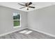 Bright bedroom with ceiling fan and gray vinyl flooring at 5 Emerald Trail Pl, Ocala, FL 34472