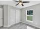 Bedroom with double sliding doors and ceiling fan at 5 Emerald Trail Pl, Ocala, FL 34472