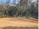 Buildable lot with cleared sand and natural landscape at 5 Emerald Trl, Ocala, FL 34472