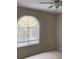 Bright bedroom with ceiling fan and large window at 5275 Images Cir # 306, Kissimmee, FL 34746