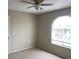 Well-lit bedroom, featuring a ceiling fan and window at 5275 Images Cir # 306, Kissimmee, FL 34746