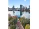 Scenic aerial view of the city skyline with a lake, fountain, lush foliage, and quaint brick-paved roads at 530 E Central Blvd # 603, Orlando, FL 32801