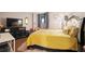 Bedroom with yellow bedding and a flat-screen TV at 530 E Central Blvd # 603, Orlando, FL 32801