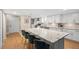 Modern kitchen featuring a large marble island, white cabinetry, stainless steel appliances, and wood flooring at 530 E Central Blvd # 603, Orlando, FL 32801