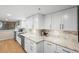 Bright kitchen featuring stainless steel appliances, a marble countertop, and clean white cabinets with plenty of storage at 530 E Central Blvd # 603, Orlando, FL 32801