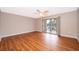 Bedroom with wood-look floors and sliding glass doors to balcony at 532 Orange Dr # 23, Altamonte Springs, FL 32701