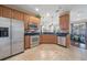 Modern kitchen with stainless steel appliances and light wood cabinets at 5441 Leighton Ln, Oviedo, FL 32765