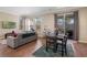 Living room with hardwood floors, gray sofa, and dining table at 5441 Leighton Ln, Oviedo, FL 32765