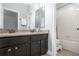 Bathroom features double vanity with granite countertop at 5590 Whispering Woods Pt, Sanford, FL 32771