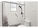 Clean bathroom with a shower, grab bars, and white tile at 5590 Whispering Woods Pt, Sanford, FL 32771