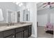 Double vanity bathroom with dark cabinets and granite countertop at 5590 Whispering Woods Pt, Sanford, FL 32771