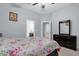 Bedroom with floral bedding and a view into the adjacent bathroom at 5590 Whispering Woods Pt, Sanford, FL 32771