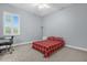 Comfortable bedroom with a red plaid bedspread and an office chair at 5590 Whispering Woods Pt, Sanford, FL 32771