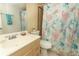 Bathroom with light wood vanity and coral shower curtain at 570 Orange Dr # 51, Altamonte Springs, FL 32701