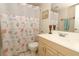 Clean bathroom with seashell shower curtain and light wood vanity at 570 Orange Dr # 51, Altamonte Springs, FL 32701