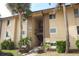 Tan building exterior with stairs and palm trees at 570 Orange Dr # 51, Altamonte Springs, FL 32701