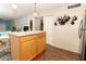 Kitchen island with light wood cabinets and a view into the living room at 570 Orange Dr # 51, Altamonte Springs, FL 32701