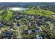 Overhead shot of a home in a golf community near a lake, highlighting its location at 5737 Masters Blvd, Orlando, FL 32819