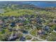 Aerial view of home, nestled in a lush, tree-lined neighborhood near a golf course and lake at 5737 Masters Blvd, Orlando, FL 32819