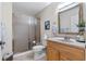 Cozy bathroom with glass enclosed shower, wooden vanity, and neutral tones at 5737 Masters Blvd, Orlando, FL 32819