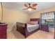 Bedroom with wooden sleigh bed, ceiling fan, and window at 5737 Masters Blvd, Orlando, FL 32819