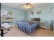 Bedroom with a full-size bed, light blue walls, and wood floors at 5737 Masters Blvd, Orlando, FL 32819