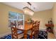 Dining room features a modern chandelier, a dark wood table and seating for six at 5737 Masters Blvd, Orlando, FL 32819