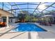 Inviting screened-in pool with hot tub and patio seating, perfect for outdoor entertaining and relaxation at 5737 Masters Blvd, Orlando, FL 32819