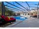 Enclosed pool area featuring a sparkling pool, lounge chairs, and a spa, offering a luxurious outdoor retreat at 5737 Masters Blvd, Orlando, FL 32819