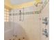 Tiled shower with a built-in seat and dual shower heads, accented by a decorative tile border at 5737 Masters Blvd, Orlando, FL 32819