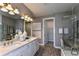 Elegant bathroom with double vanity, a large glass shower, and a view into the bedroom at 6375 Dew Drop Loop, St Cloud, FL 34771