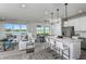 Modern kitchen boasts white cabinets, stainless steel appliances, and an island at 6375 Dew Drop Loop, St Cloud, FL 34771