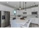 Modern kitchen with white cabinets, stainless steel appliances and quartz countertops at 6375 Dew Drop Loop, St Cloud, FL 34771