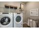 Laundry room with Whirlpool appliances and extra storage at 6375 Dew Drop Loop, St Cloud, FL 34771