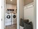 Laundry room with built-in seating and Whirlpool appliances at 6375 Dew Drop Loop, St Cloud, FL 34771