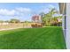 Landscaped backyard with lush grass, offering a serene outdoor view at 8146 Prestbury Dr, Orlando, FL 32832