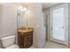 Small bathroom with granite vanity, shower, and private access door at 8146 Prestbury Dr, Orlando, FL 32832