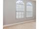 Bedroom with two arched windows and neutral wall color at 8146 Prestbury Dr, Orlando, FL 32832