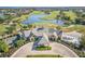 Aerial view of a clubhouse with a clock tower, situated near a golf course at 8146 Prestbury Dr, Orlando, FL 32832