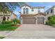 Two-story home with tile roof, stone accents, and a two-car garage at 8146 Prestbury Dr, Orlando, FL 32832