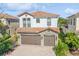 Two-story home with tile roof, stone accents, and a two-car garage at 8146 Prestbury Dr, Orlando, FL 32832